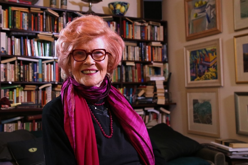 Ms Warnock at home in front of a book case.