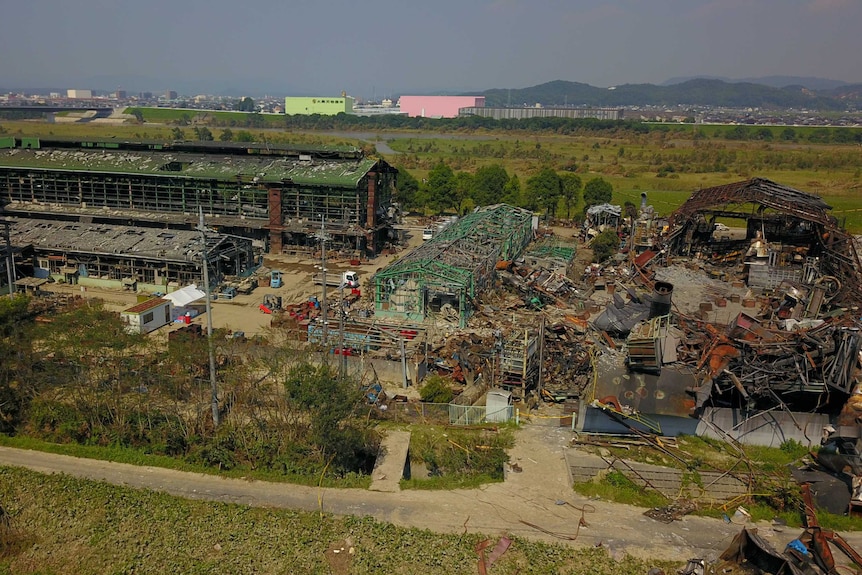 An aerial photo shows gutted factories after an explosion.