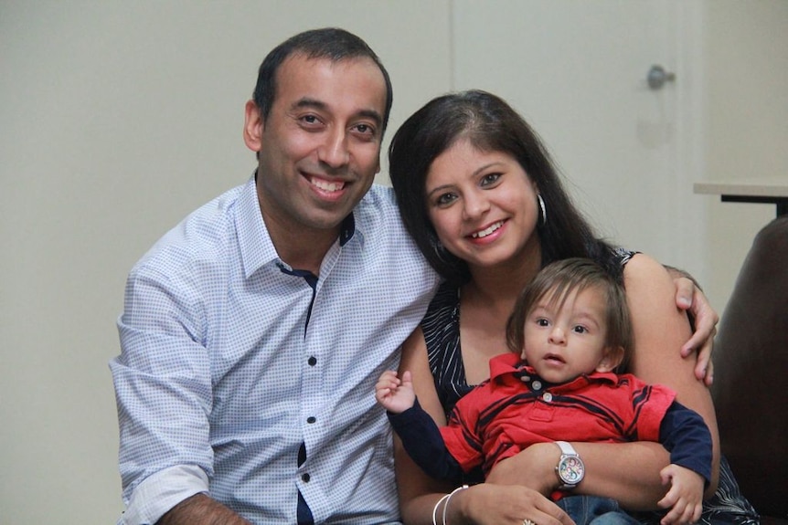 Harjot Singh is seen sitting with his wife Misha and son Kiaan.