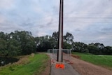 A large concrete pole in the middle of a bike path