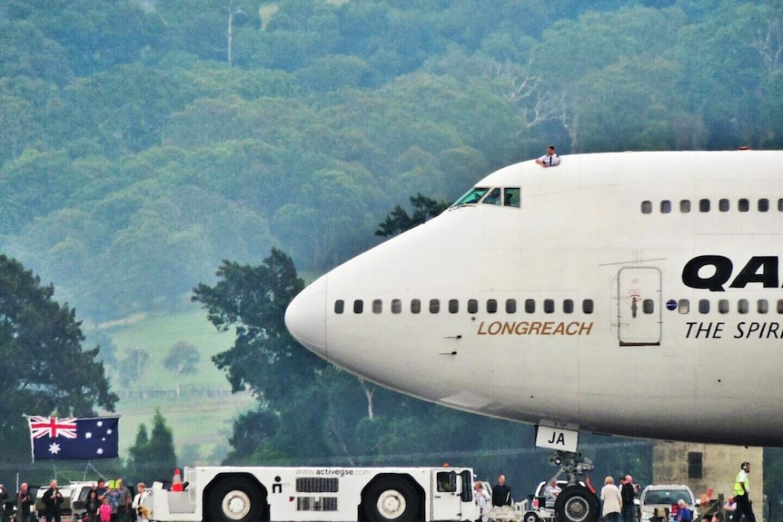 Pilot pokes his body out of cockpit hatch