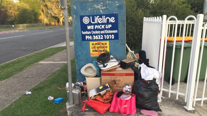 Broken items left outside charity donation bin