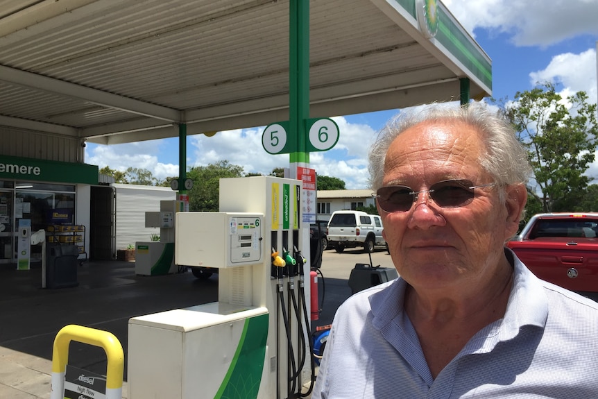Gracemere BP owner of 35 years Glenn Lynch stands near a fuel pump.