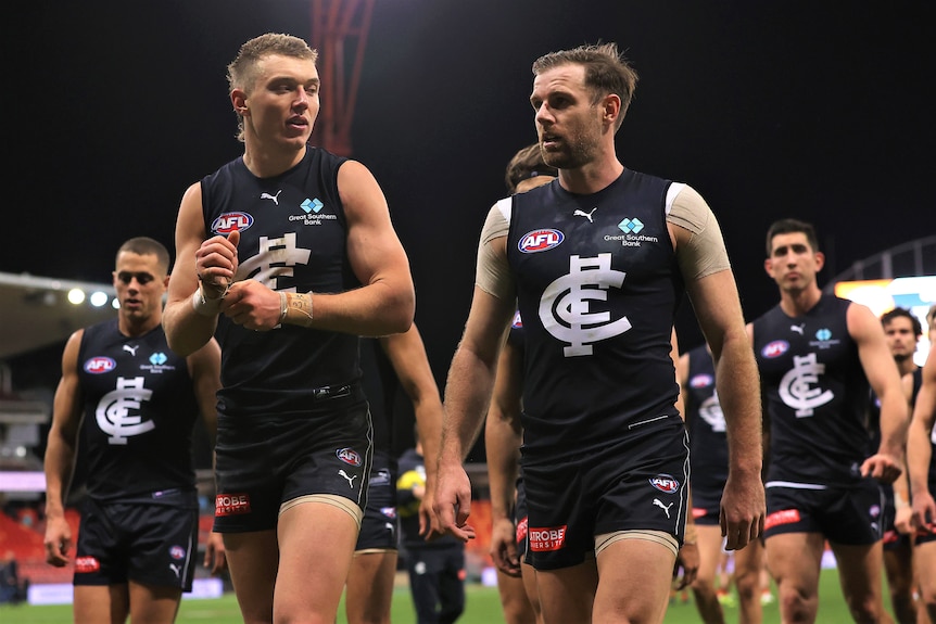 A group of AFL players walking off the field together