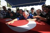 The mother of a Turkish police officer killed in an attack mourns over her son's coffin