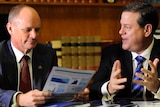 Tim Nicholls (right) and Campbell Newman read through budget papers.