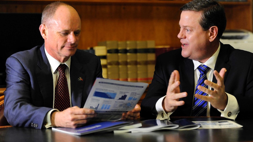 Queensland Treasurer Tim Nicholls (right) and Premier Campbell Newman read through the budget papers.