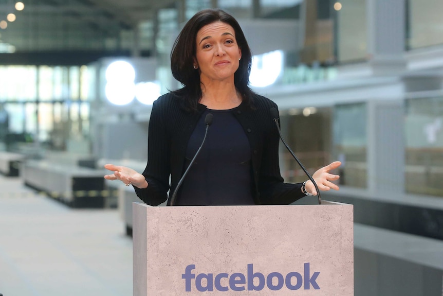 Facebook's Sheryl Sandberg greets media in Paris metro station on a 'Facebook' lectern.