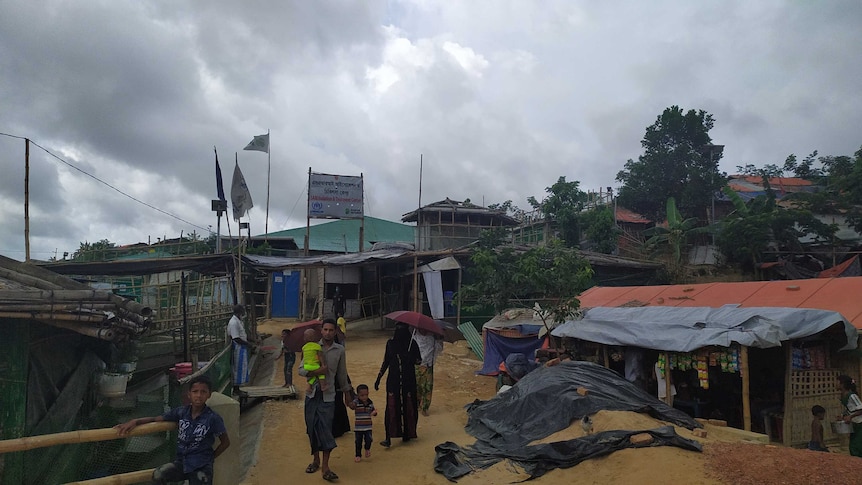 A view of the SARI isolation and Treatment Centre with a few refugees walking around.