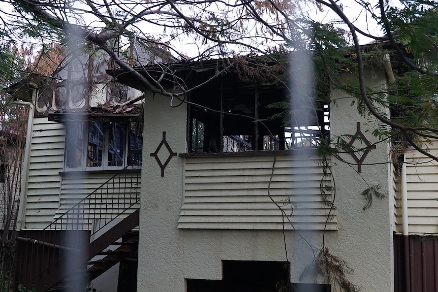 A house with the interior visibly blackened through the windows.