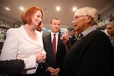 A woman confronts Julia Gillard during a visit to a shopping centre in Brisbane.