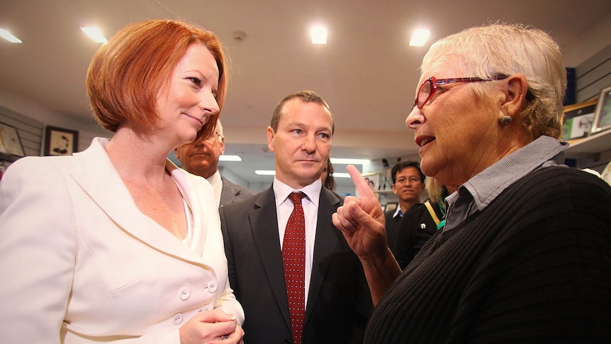 A woman confronts Julia Gillard during a visit to a shopping centre in Brisbane.