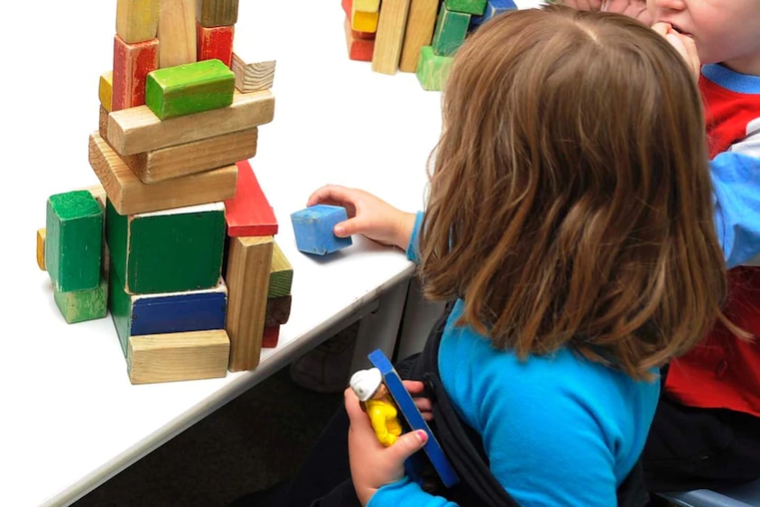 A child plays at a table.