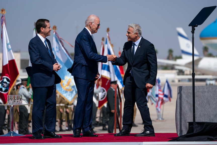     President Joe Biden gives a fist to Israeli Prime Minister Yair Lapid.