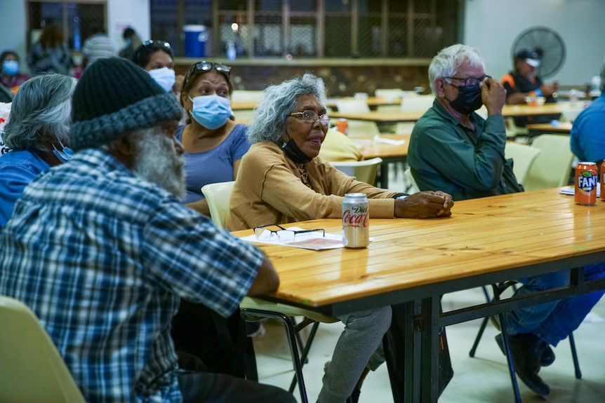 A group of Aboriginal people sit at a table