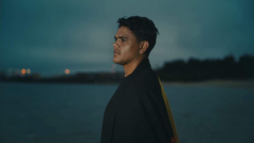 Latrell Mitchell looks out to sea in a screenshot from the NRL's advertisement for the 2020 season.