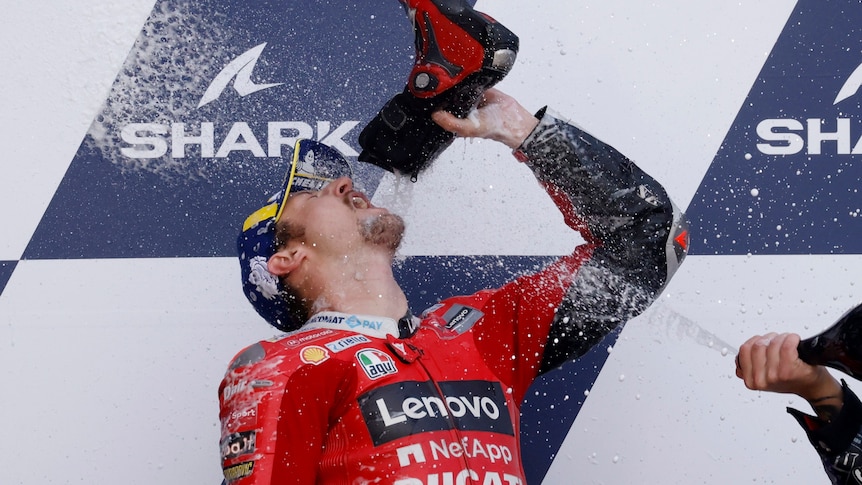 MotoGP rider celebrates winning by drinking out of his shoe.