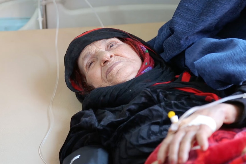 A woman with cholera lies in a hospital bed in Yemen.