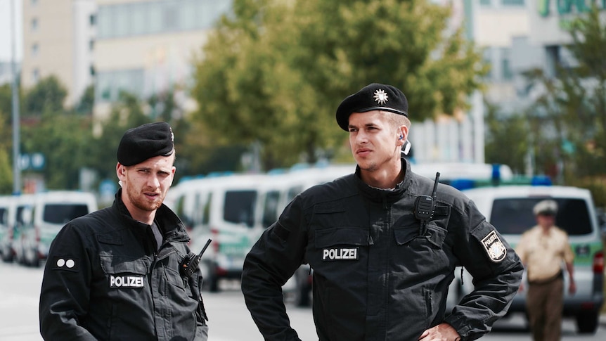 Two German police officers stand on the street