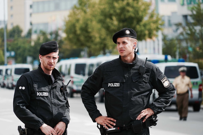Two German police officers stand on the street