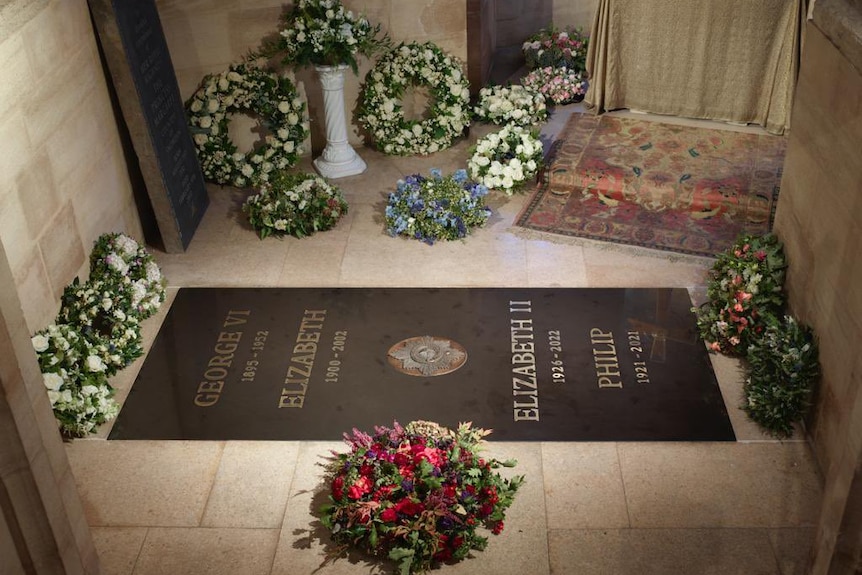 P photo of the ledger stone surrounded by wreaths of flowers. 
