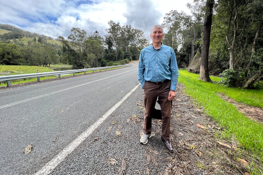 man standing in front of road