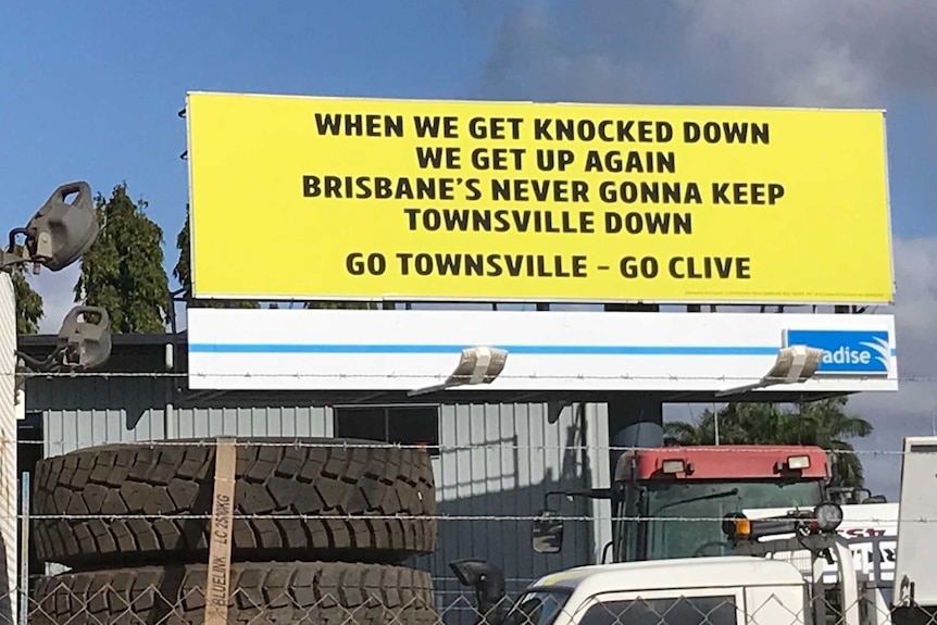 A billboard includes the words 'Go Townsville, Go Clive'