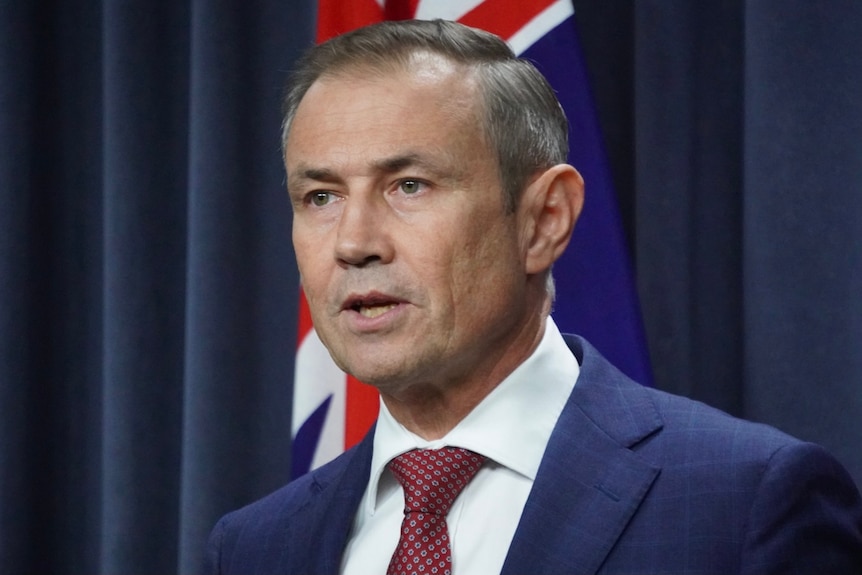 A head and shoulders shot of WA Health Minister Roger Cook speaking at a media conference.