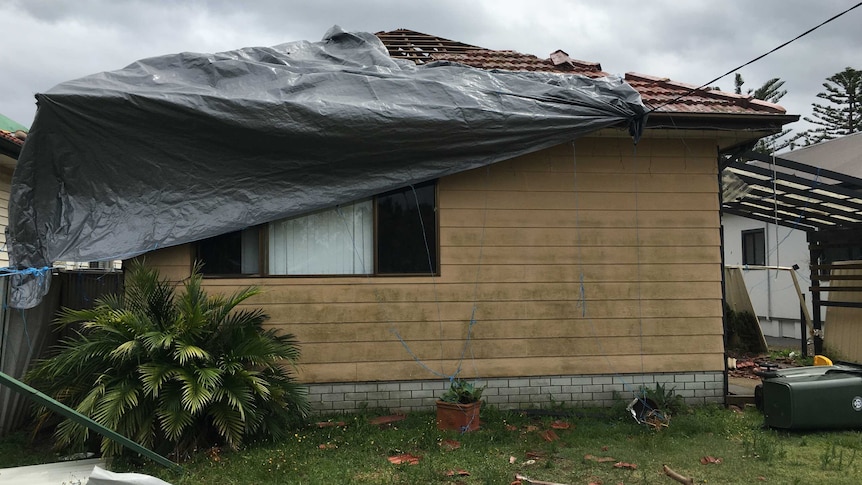 Wild weather in Sydney rips a tarp off a home in Kurnell, just a month after it was damaged in a tornado.