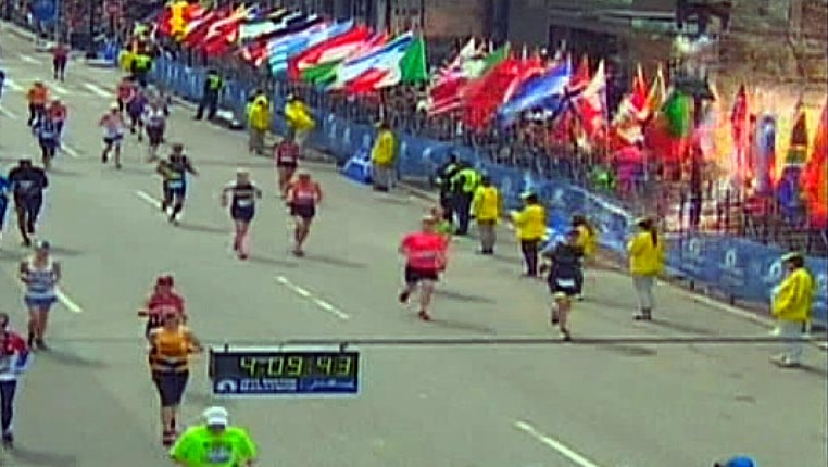 A bomb explodes next to the finish line of the Boston Marathon.