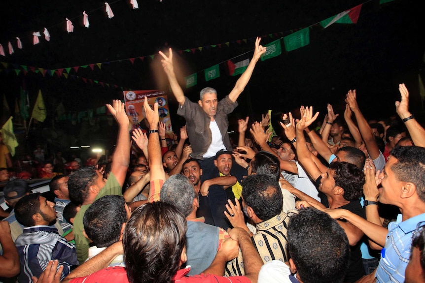 A freed Palestinian prisoner is greeted by his relatives upon arrival in Gaza.