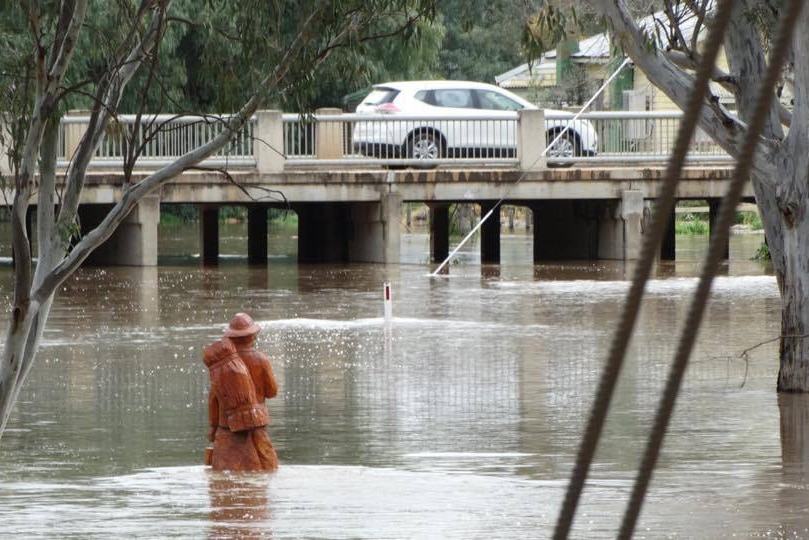 A sculpture of a swagman knee-deep in rising floodwaters in Charlton.