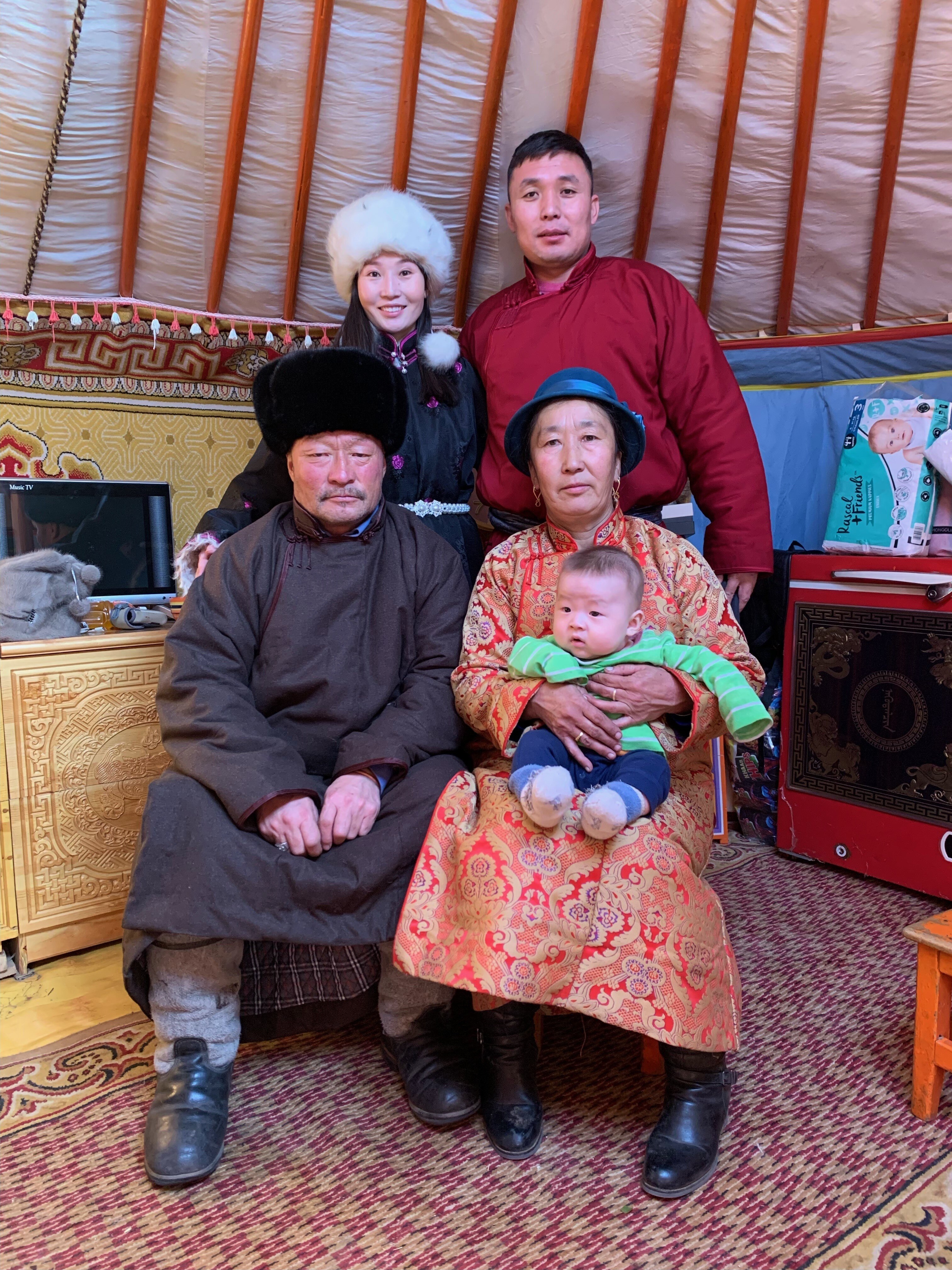 A mongolian family smiles.