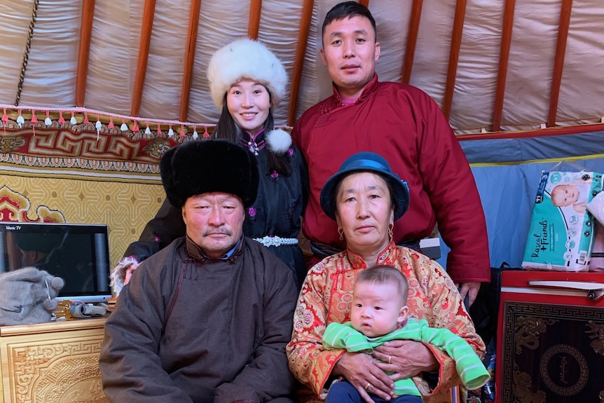 A mongolian family smiles.