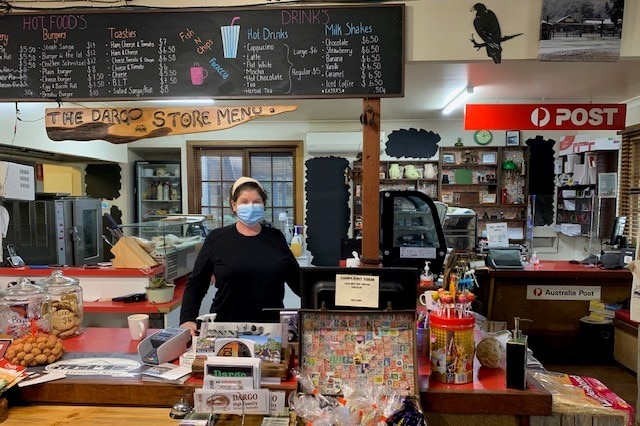 Kerry Leemonl stands in Dargo general storel wearing mask