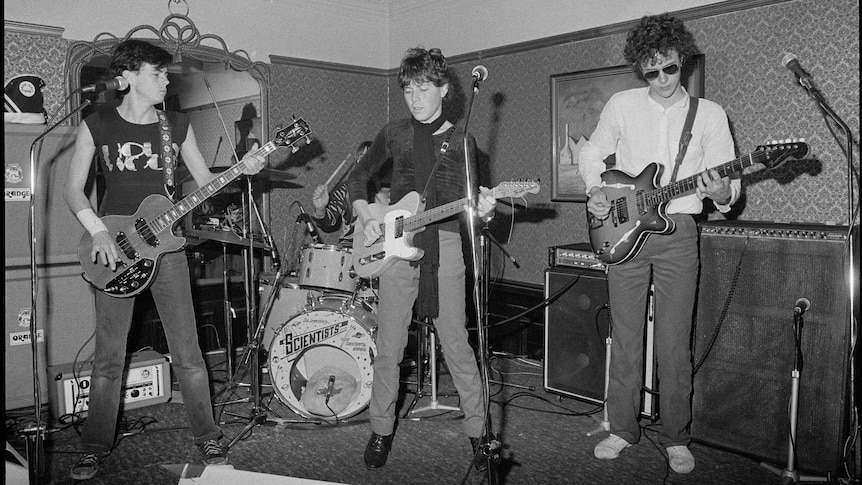 Black and white photo of band The Scientists on a stage