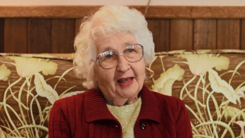 Mary White sits on a couch.