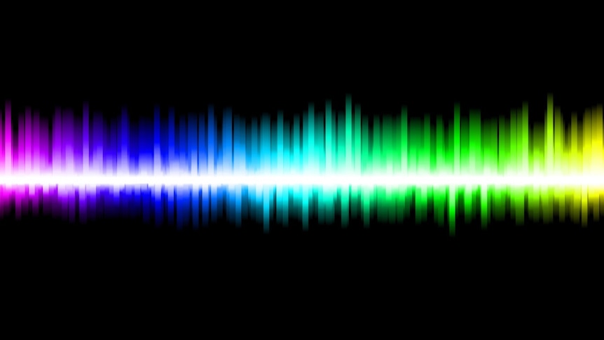 Rainbow light in the form of soundwaves on a black background.