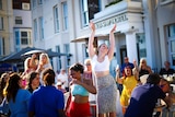 A group of women dancing at an outdoor pub