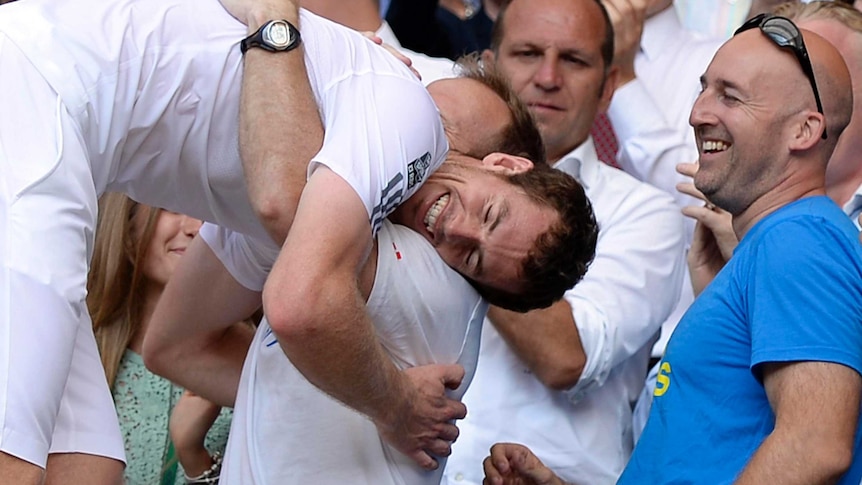 Andy Murray celebrates on the players' box.