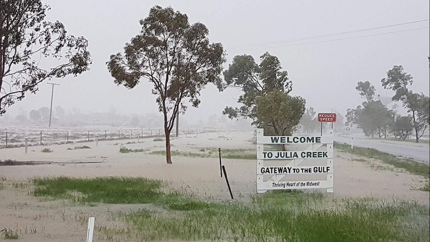 Welcome to Julia Creek sign on flooded roads after torrential rain March 5, 2018.