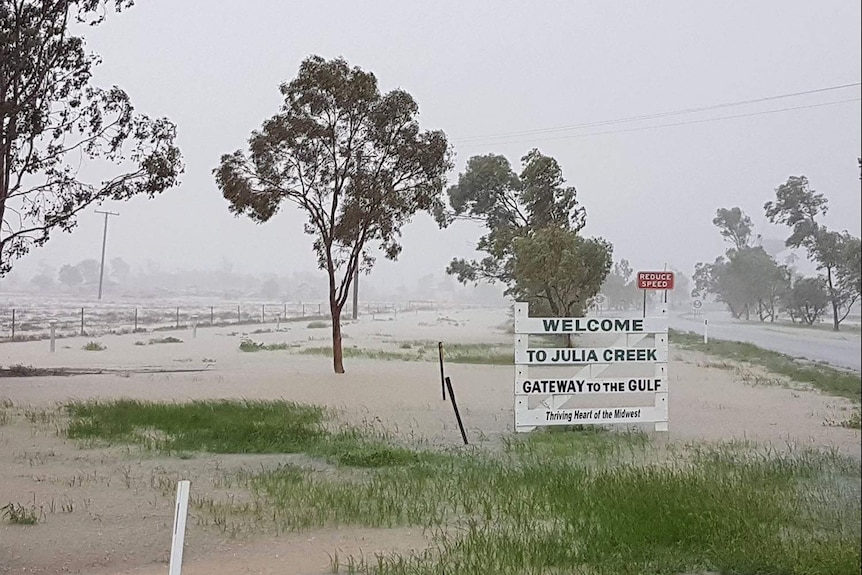 Welcome to Julia Creek sign on flooded roads after torrential rain March 5, 2018.