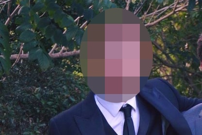 A pixelated photo of the accused man in a suit.