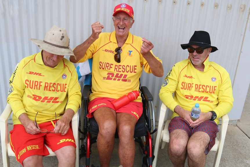 Three men sit together wearing surf rescue jersies.