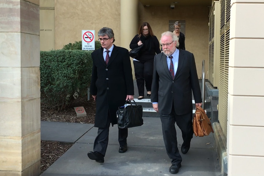 Dr Michael Metz walks from the coroner's court