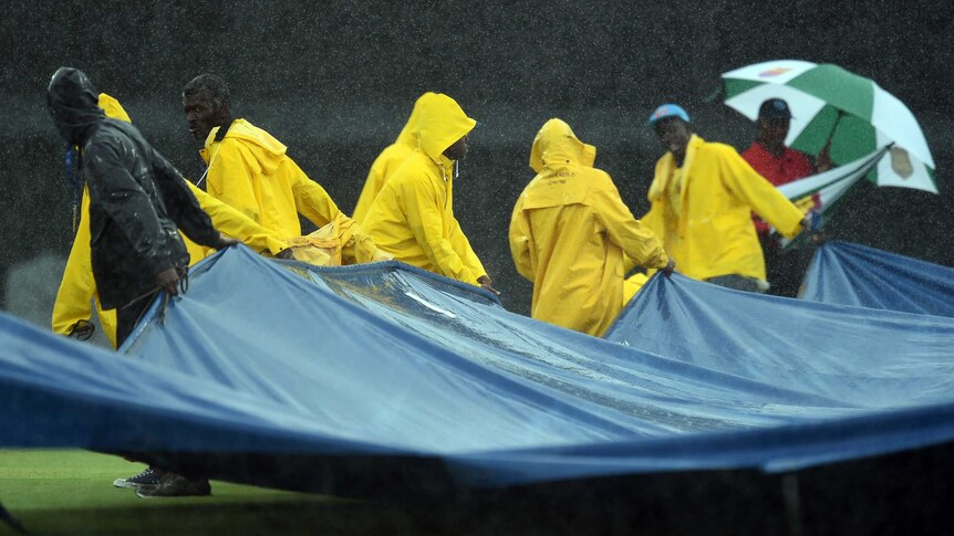 Groundsmen pull covers on as rain stops play in Australia v Sth Africa ODI in Barbados.