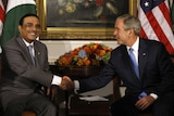 Bush shakes hands with Pakistan's Zardari