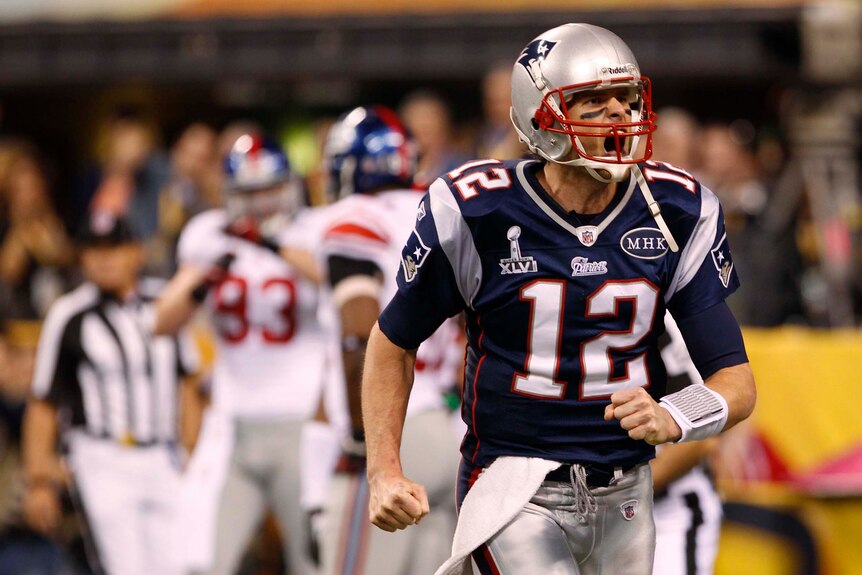New England Patriots quarterback Tom Brady shouts after throwing a touchdown pass
