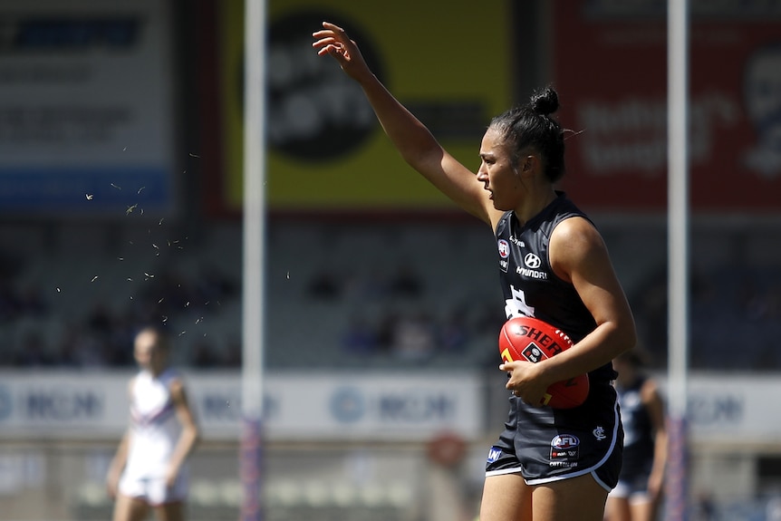 Darcy Vescio of the Blues prepares to kick for goal by floating grass in the wind during the 2021 AFLW Round 07 match 