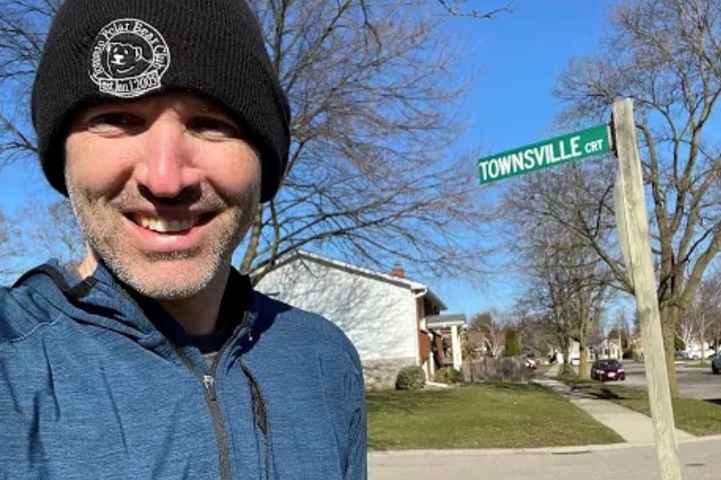 Townsville man Dan Schaumann stands in front of a street sign for Townsville Court in Ontario, Canada.